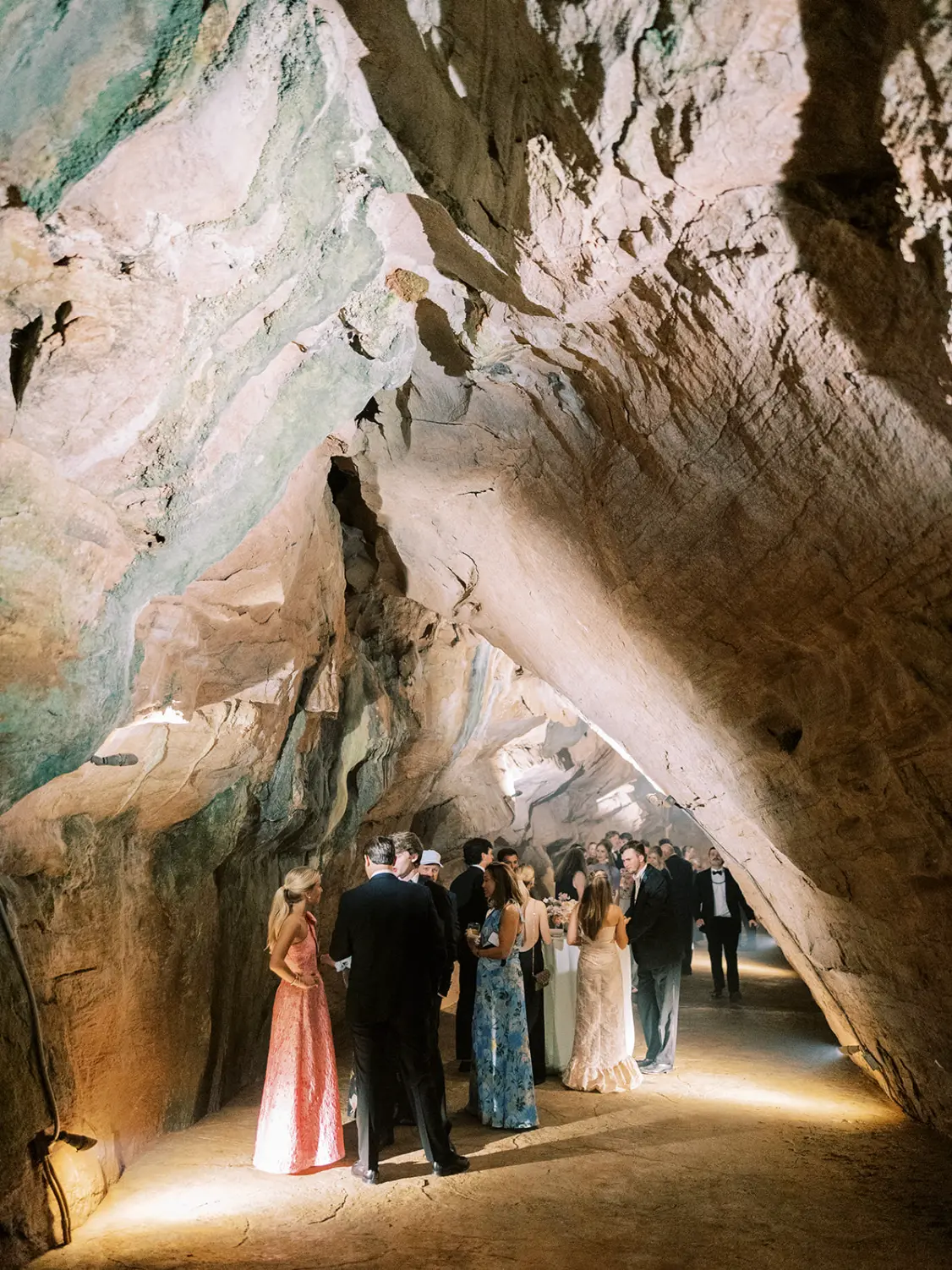 Wedding guests gathered in a softly lit cave